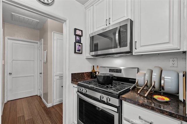 2218 Ximeno Ave, Long Beach, CA 90815 - kitchen with appliances with stainless steel finishes, white cabinetry, wood finished floors, and dark stone counters