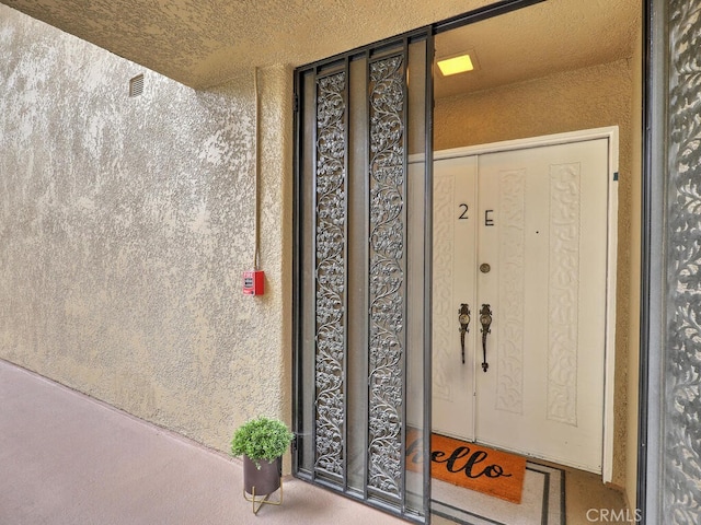 2390 Via Mariposa W Unit 2E, Laguna Woods, CA 92637 - property entrance featuring stucco siding
