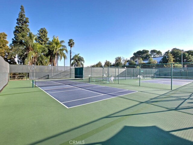 2390 Via Mariposa W Unit 2E, Laguna Woods, CA 92637 - view of tennis court with fence and community basketball court
