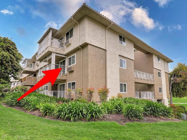 2390 Via Mariposa W Unit 2E, Laguna Woods, CA 92637 - view of property with a wall unit AC