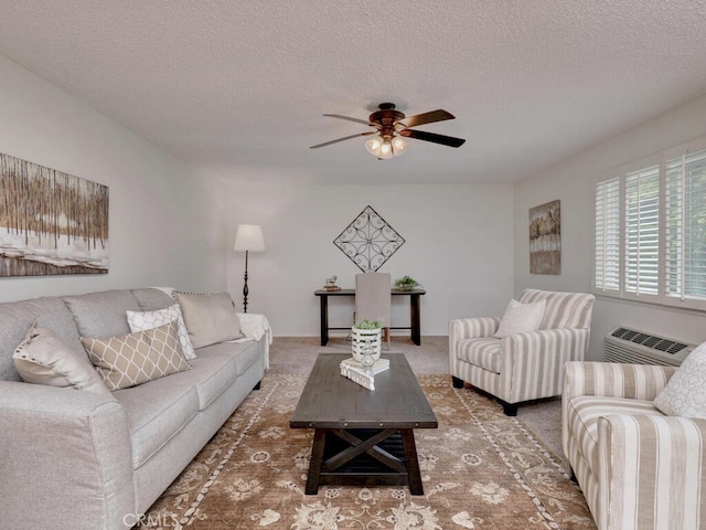 2390 Via Mariposa W Unit 2E, Laguna Woods, CA 92637 - living room with a textured ceiling, ceiling fan, a wall unit AC, and carpet flooring