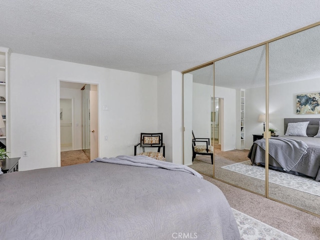 2390 Via Mariposa W Unit 2E, Laguna Woods, CA 92637 - bedroom with carpet, a closet, and a textured ceiling