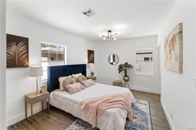11445 Saticoy St, North Hollywood, CA 91605 - bedroom with baseboards, a chandelier, and wood finished floors