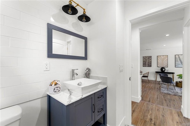 11445 Saticoy St, North Hollywood, CA 91605 - bathroom featuring wood finished floors, toilet, vanity, and baseboards