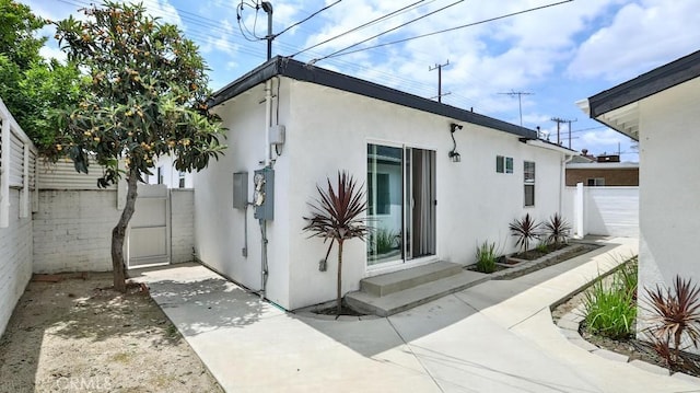 11445 Saticoy St, North Hollywood, CA 91605 - view of side of property with stucco siding and a patio area