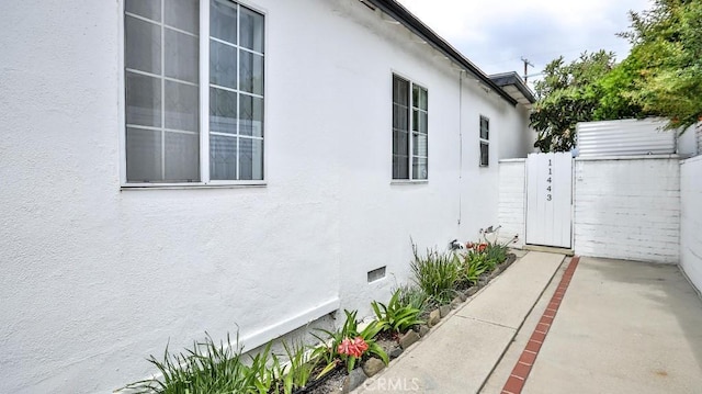11445 Saticoy St, North Hollywood, CA 91605 - view of side of home with stucco siding and a gate