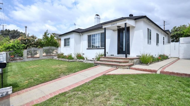 11445 Saticoy St, North Hollywood, CA 91605 - view of front of home featuring a gate, stucco siding, and a chimney