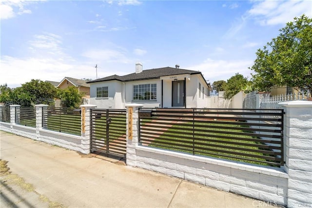 11445 Saticoy St, North Hollywood, CA 91605 - view of front of property with stucco siding, a fenced front yard, and a gate