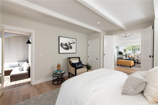 567 Flora St, Laguna Beach, CA 92651 - bedroom featuring beamed ceiling, an inviting chandelier, light wood-style flooring, and baseboards