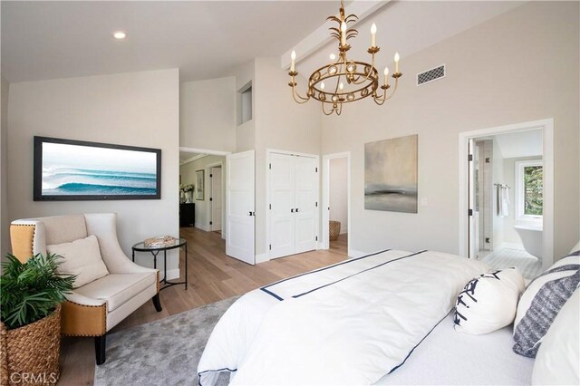 567 Flora St, Laguna Beach, CA 92651 - bedroom with light wood finished floors, a notable chandelier, high vaulted ceiling, visible vents, and baseboards