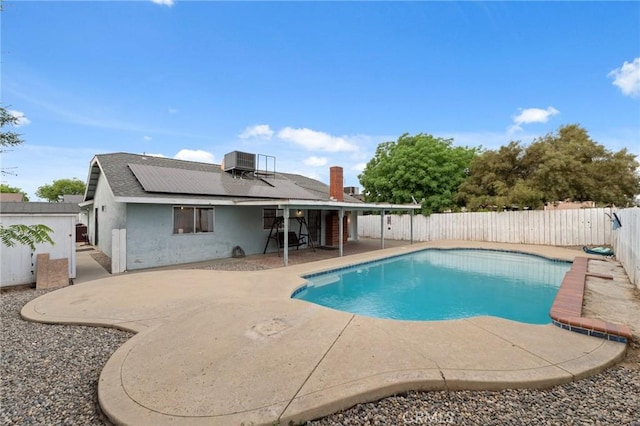 1045 Clover Ln, Hanford, CA 93230 - view of swimming pool with a patio, a fenced backyard, and central air condition unit