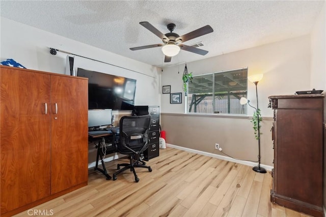 1045 Clover Ln, Hanford, CA 93230 - home office with a ceiling fan, wood finished floors, a textured ceiling, and baseboards