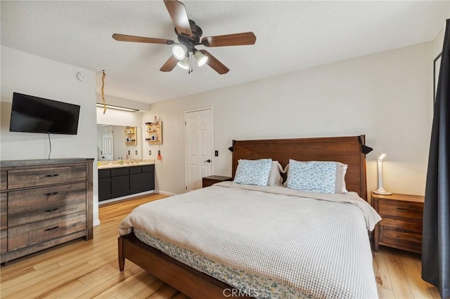 1045 Clover Ln, Hanford, CA 93230 - bedroom with light wood finished floors, ensuite bathroom, and a ceiling fan