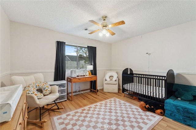 1045 Clover Ln, Hanford, CA 93230 - bedroom with wood finished floors, a textured ceiling, and a ceiling fan