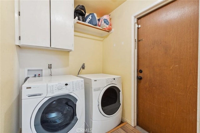 1045 Clover Ln, Hanford, CA 93230 - clothes washing area featuring cabinet space, separate washer and dryer, and light wood-style flooring
