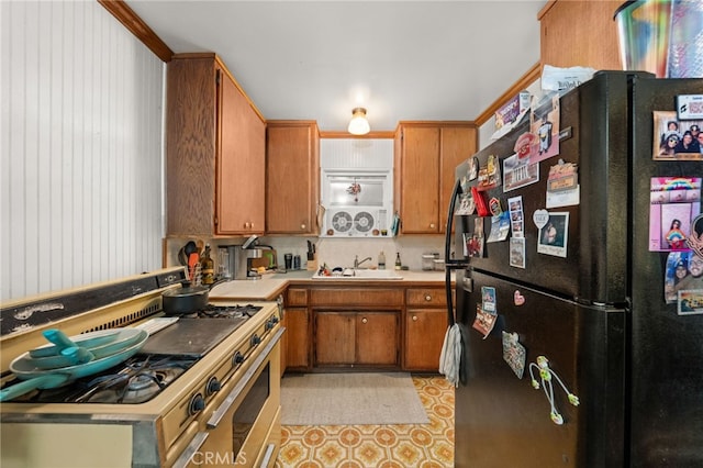 12652 Oaks Ave, Chino, CA 91710 - kitchen featuring freestanding refrigerator, range with two ovens, a sink, light countertops, and brown cabinets