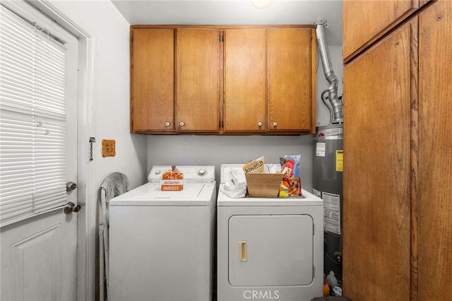 laundry room with cabinet space, washer and clothes dryer, and water heater