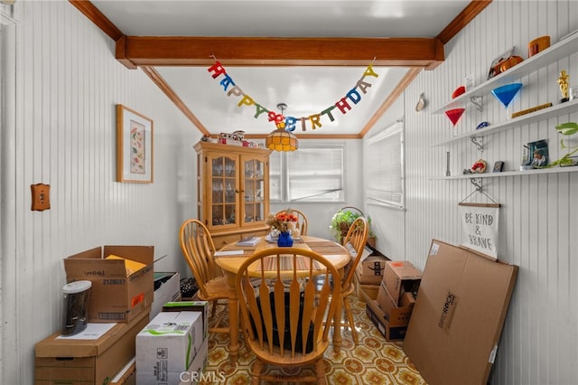 dining space with beam ceiling