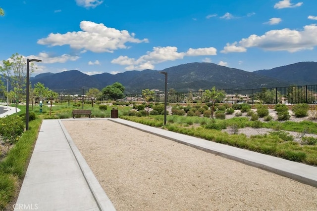 view of home's community with fence and a mountain view