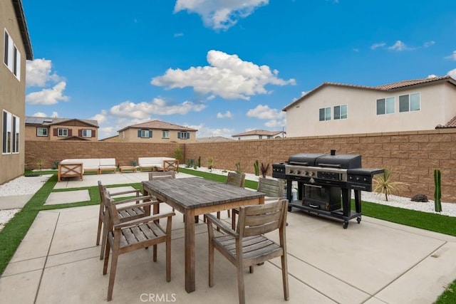 view of patio featuring an outdoor living space, outdoor dining area, and a fenced backyard