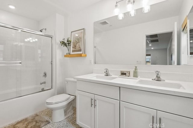 bathroom with visible vents, a sink, double vanity, and toilet