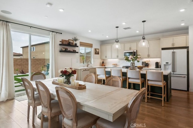 dining room with visible vents, recessed lighting, and light wood finished floors