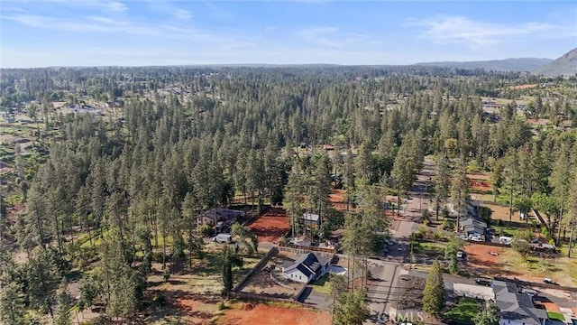 birds eye view of property with a wooded view