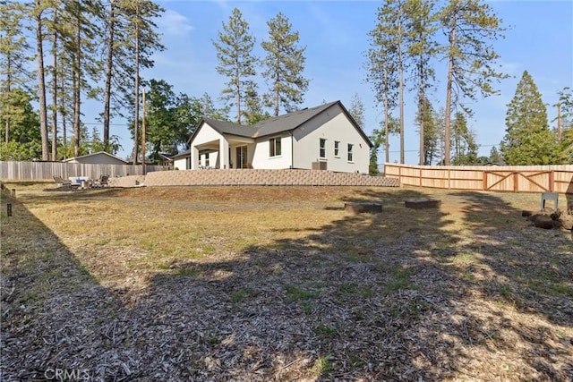 view of home's exterior with stucco siding and a fenced backyard