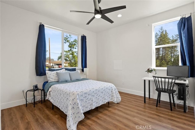 bedroom with recessed lighting, ceiling fan, wood finished floors, and baseboards