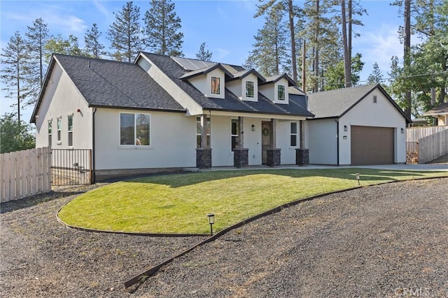 new england style home featuring roof mounted solar panels, stucco siding, covered porch, a front yard, and fence