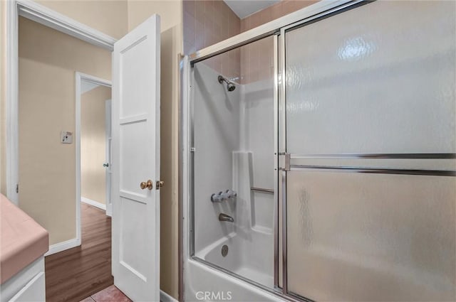 7518 Loch Alene Ave, Pico Rivera, CA 90660 - full bathroom featuring shower / bath combination with glass door, wood finished floors, vanity, and baseboards