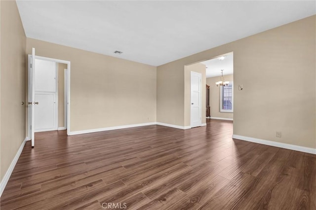 7518 Loch Alene Ave, Pico Rivera, CA 90660 - unfurnished room featuring visible vents, a notable chandelier, baseboards, and dark wood finished floors