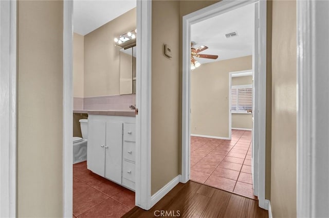 7518 Loch Alene Ave, Pico Rivera, CA 90660 - half bath with tile patterned flooring, ceiling fan, toilet, vanity, and visible vents
