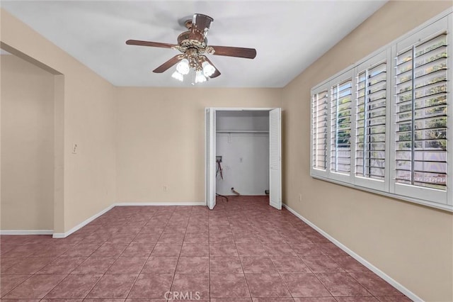 7518 Loch Alene Ave, Pico Rivera, CA 90660 - unfurnished bedroom with tile patterned floors, baseboards, ceiling fan, and a closet