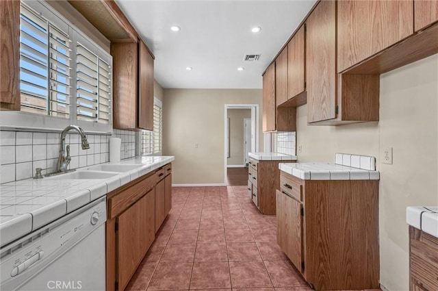 7518 Loch Alene Ave, Pico Rivera, CA 90660 - kitchen featuring backsplash, dishwasher, a sink, visible vents, and tile countertops