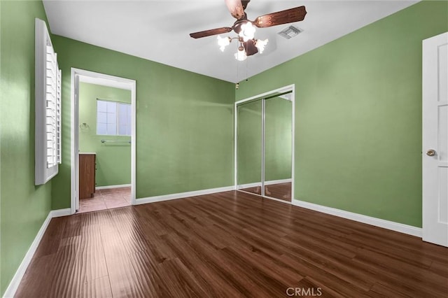 7518 Loch Alene Ave, Pico Rivera, CA 90660 - unfurnished bedroom with wood finished floors, a closet, ensuite bathroom, baseboards, and visible vents