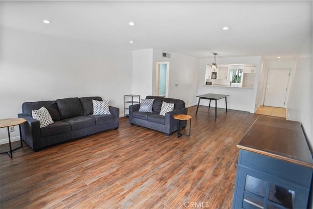 living room featuring recessed lighting, wood finished floors, and visible vents