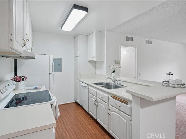 23515 Lyons Ave Unit 286, Valencia, CA 91355 - kitchen with white appliances, a peninsula, light countertops, and light wood finished floors