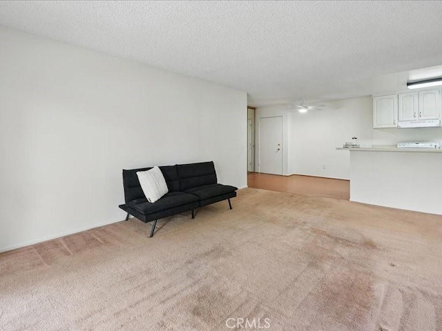 23515 Lyons Ave Unit 286, Valencia, CA 91355 - living area with light colored carpet, a ceiling fan, and a textured ceiling