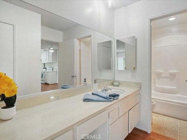 23515 Lyons Ave Unit 286, Valencia, CA 91355 - full bath with vanity, a textured ceiling, shower / bathtub combination, ceiling fan, and washer / clothes dryer