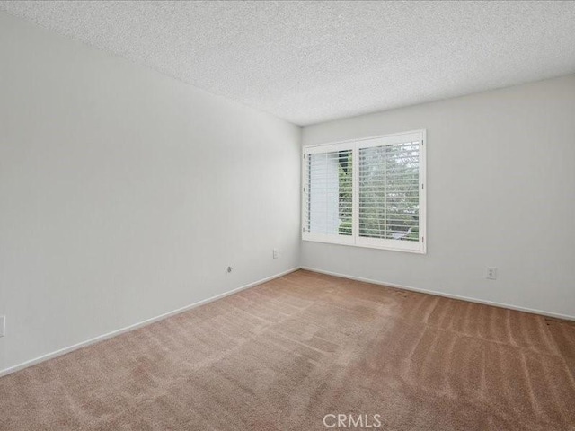 23515 Lyons Ave Unit 286, Valencia, CA 91355 - carpeted spare room with baseboards and a textured ceiling