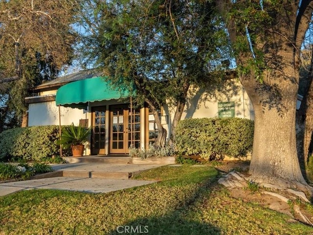 23515 Lyons Ave Unit 286, Valencia, CA 91355 - back of property with french doors and stucco siding