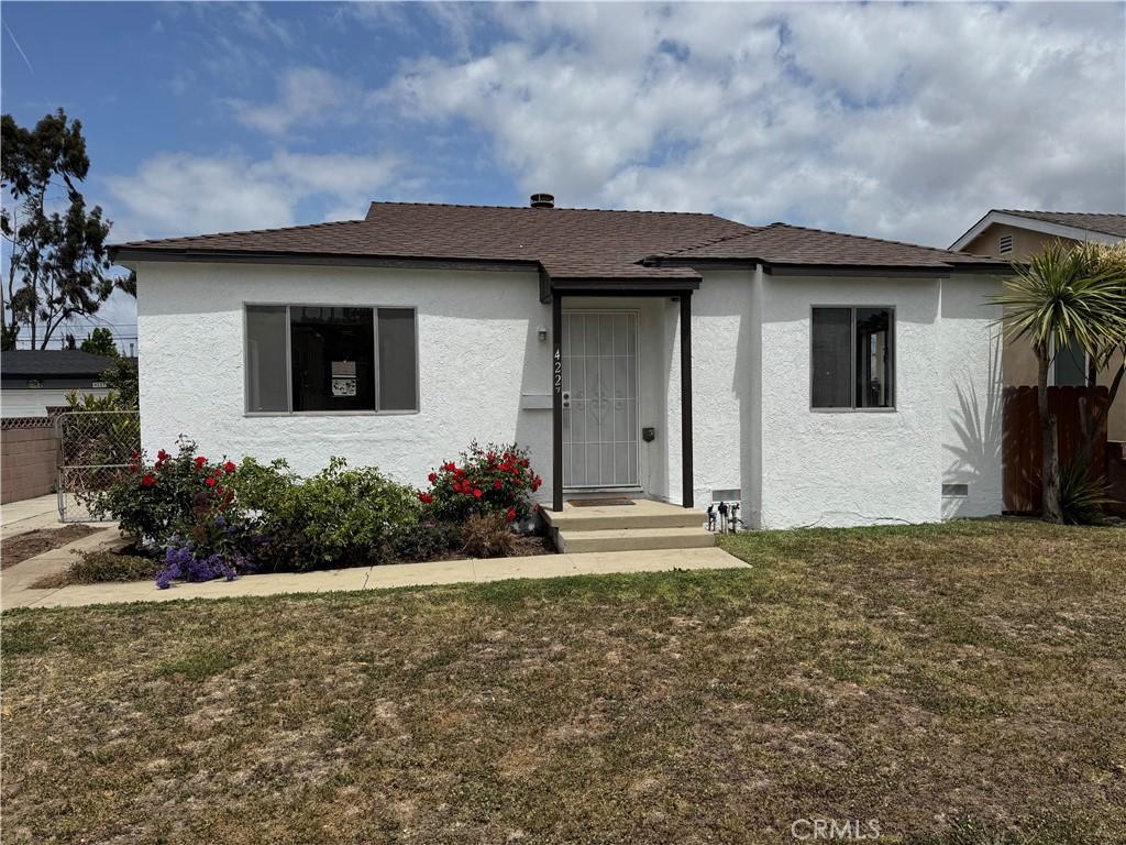 4227 W 168th St, Lawndale, CA 90260 - view of front of property with fence, stucco siding, and a front yard