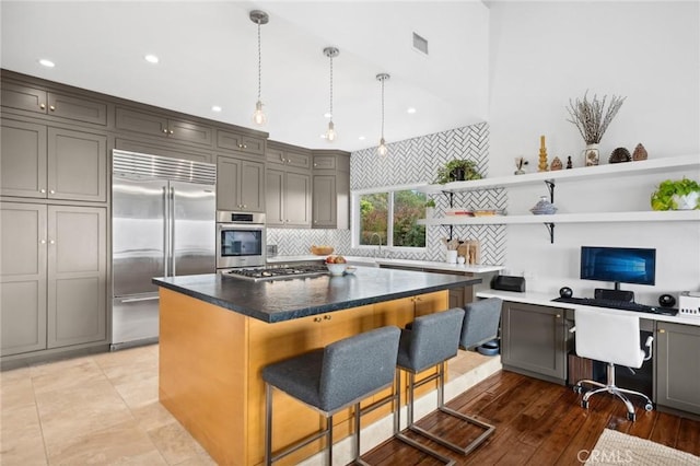 kitchen with gray cabinetry, visible vents, stainless steel appliances, and open shelves