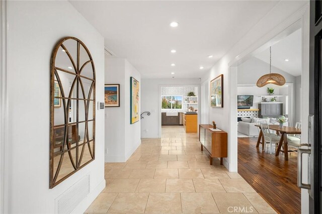 corridor featuring recessed lighting, light tile patterned flooring, and baseboards