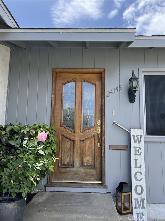 view of exterior entry featuring board and batten siding