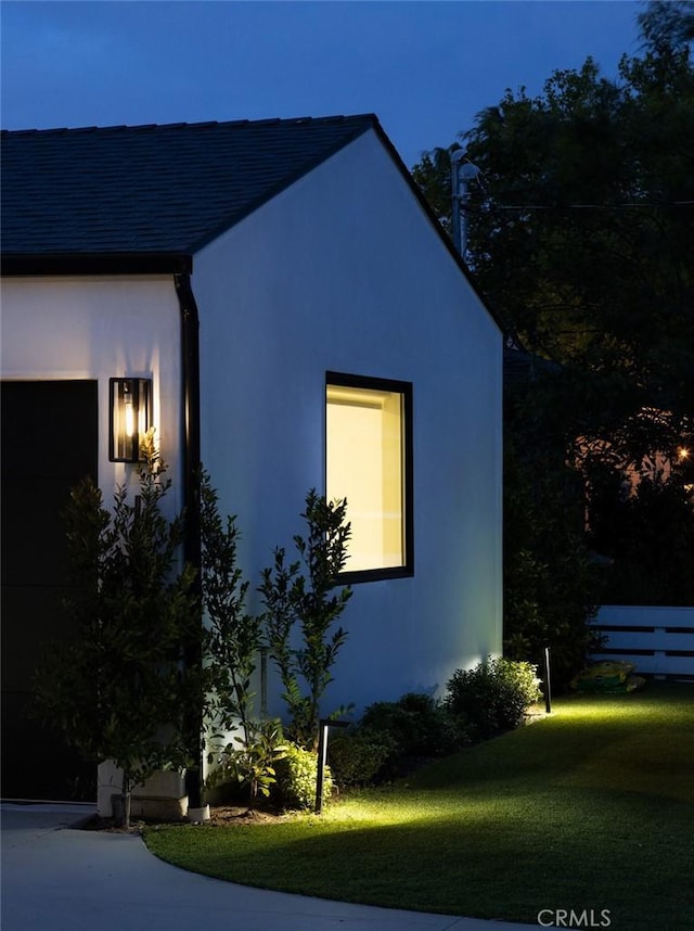 286 Cecil Pl, Costa Mesa, CA 92627 - property exterior at twilight featuring stucco siding, fence, and a lawn
