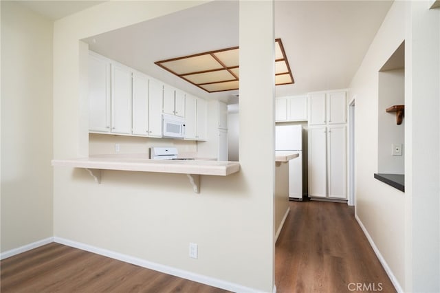 432 W Caldwell Ct, San Dimas, CA 91773 - kitchen featuring white appliances, dark wood-type flooring, a breakfast bar, and white cabinets