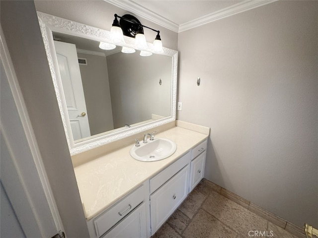bathroom with visible vents, vanity, ornamental molding, and baseboards