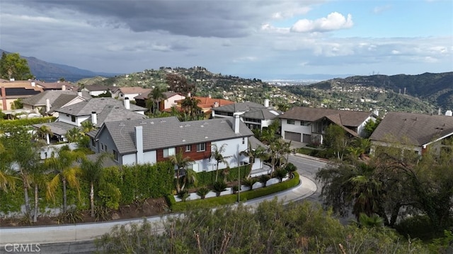 birds eye view of property with a mountain view and a residential view